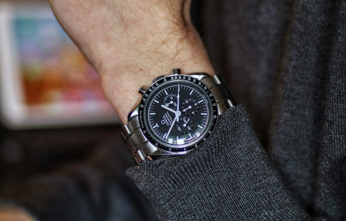 person wearing silver round chronograph watch